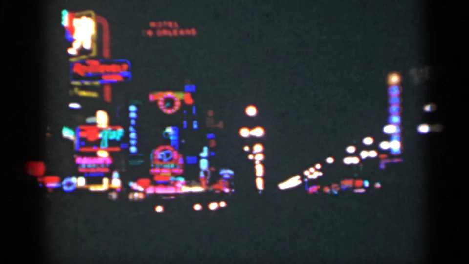 New Orleans nightlife scene with stacked neon signage, streetlamps, and approaching headlights in grainy 8mm footage.