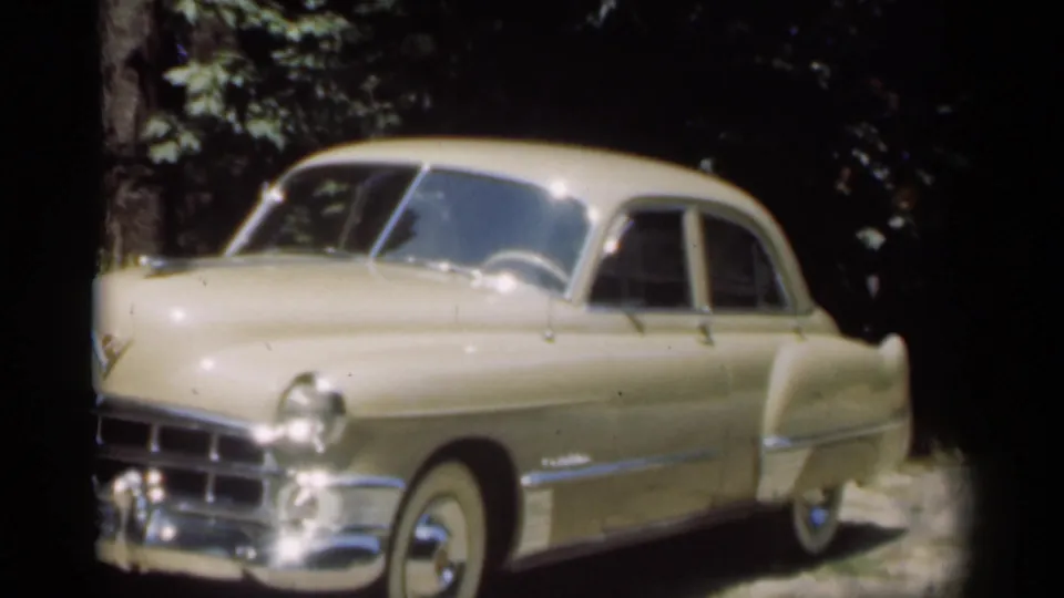 Cream Chevrolet sedan parked in a tree-lined driveway in New Orleans, captured in 1949 8mm home-movie footage.