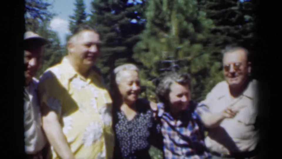 A 1949 New Orleans outdoor group moment shows adults smiling in sunlit trees, with a partial figure entering at left.