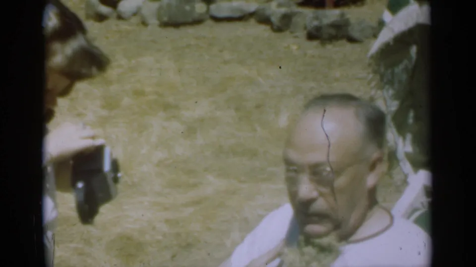 The older man lowers his gaze as the woman with the dark camera remains at the edge of the 1949 Santa Cruz home-movie frame.