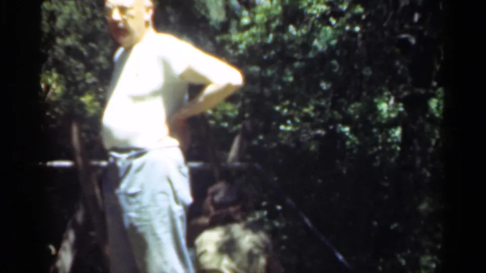 The closing frame shows the man in light clothing standing in a wooded Santa Cruz setting, with another person crouched near the ground.