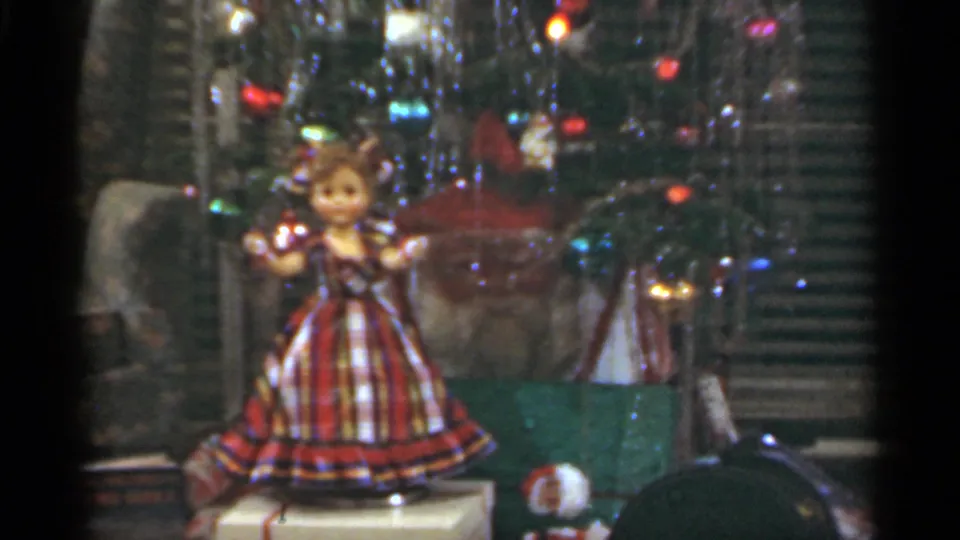 A dressed doll appears in a reflective display window, likely part of the same 1949 Santa Cruz home-movie reel.