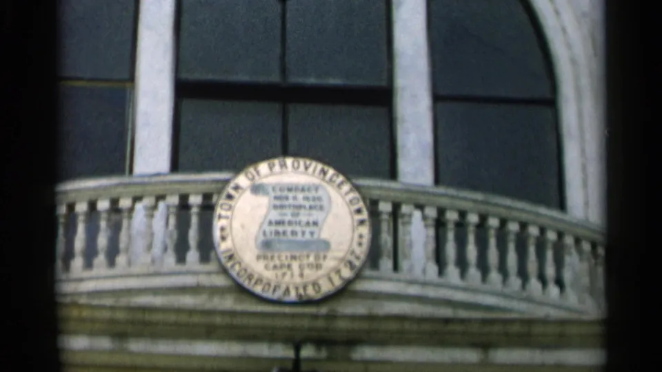 Close view of the Town of Provincetown seal on a balcony facade in Cape Cod footage.