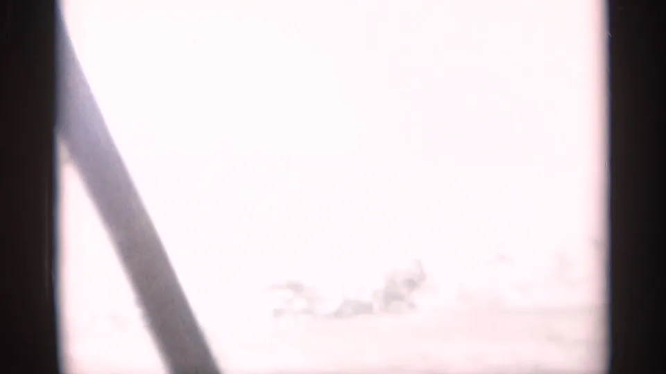 Overexposed 1956 Cape Cod car-window view with a dark diagonal window frame and faint roadside shapes beyond the glass.