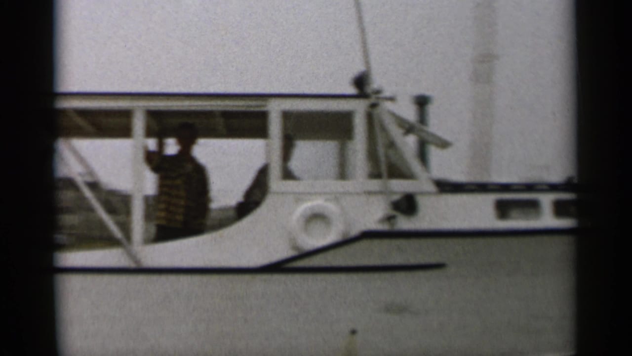 Close side view of the motorboat cabin with a passenger visible inside.