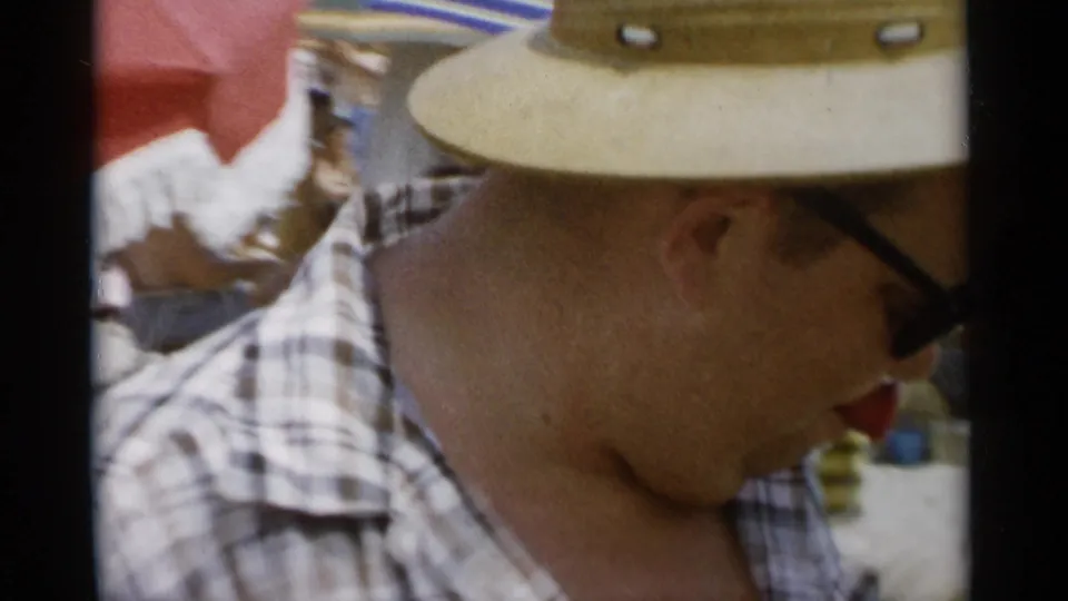 A side close-up shows the man in a straw hat and sunglasses, with beachgoers and umbrellas behind him at Jones Beach.