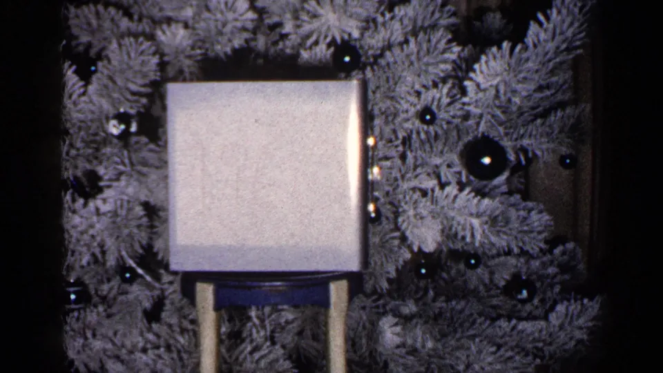 1960 Duluth home-movie still with the square object slightly lower in frame before the decorated flocked tree.
