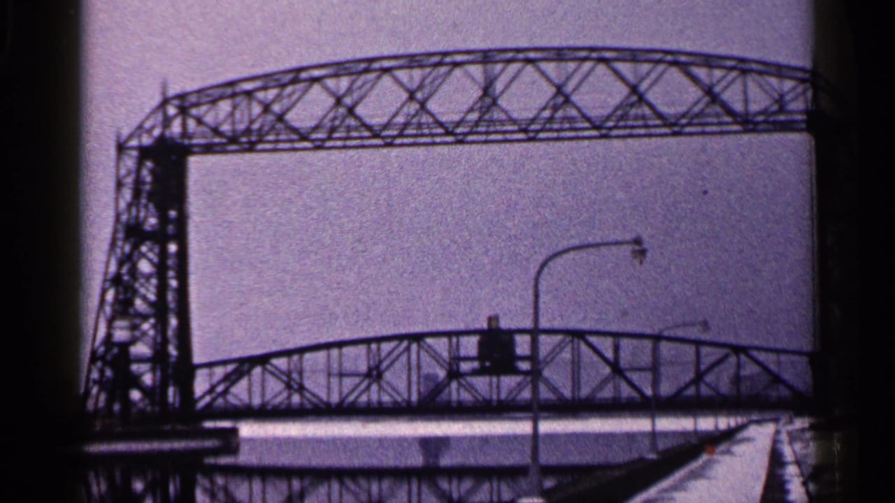 Duluth winter bridge view with the truss span crossing the frame and a streetlight in the snowy foreground.