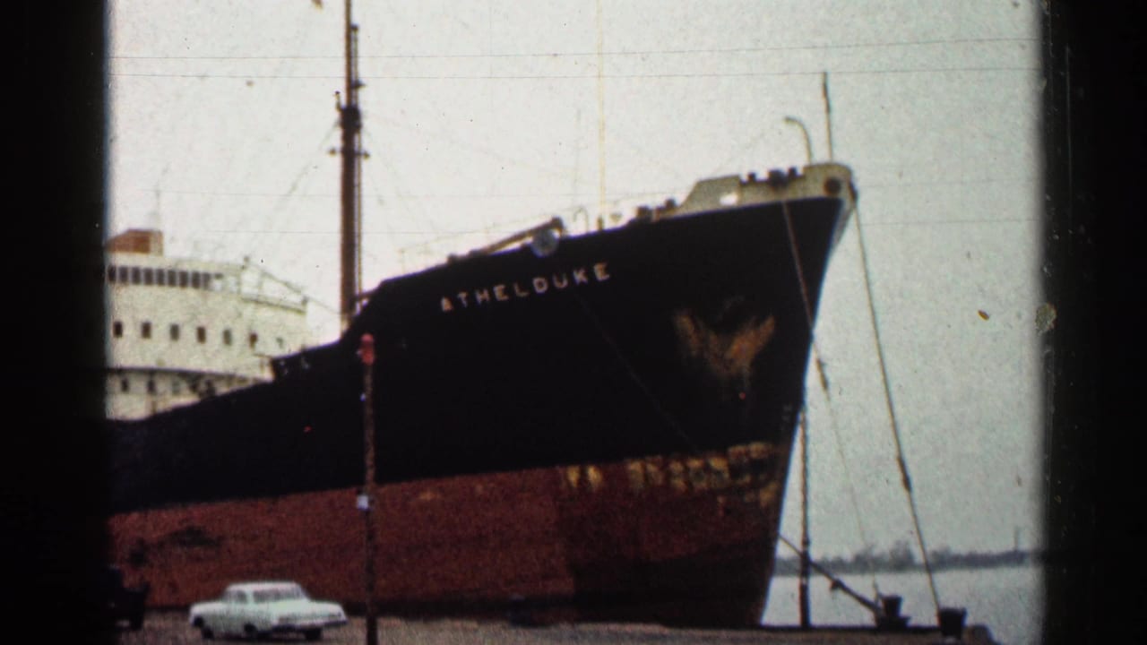 Large black and rust-red ship bow with the name ATHELDUKE visible at the dock.