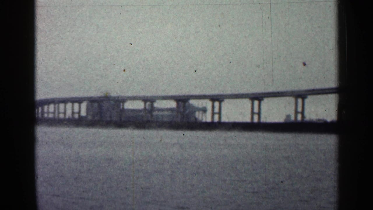 Bridge section with repeated supports seen across water.