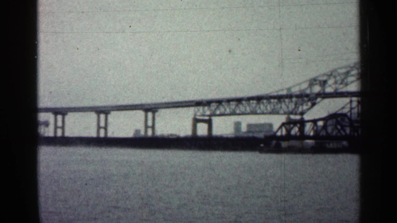 Long bridge span and truss section over rippling water.