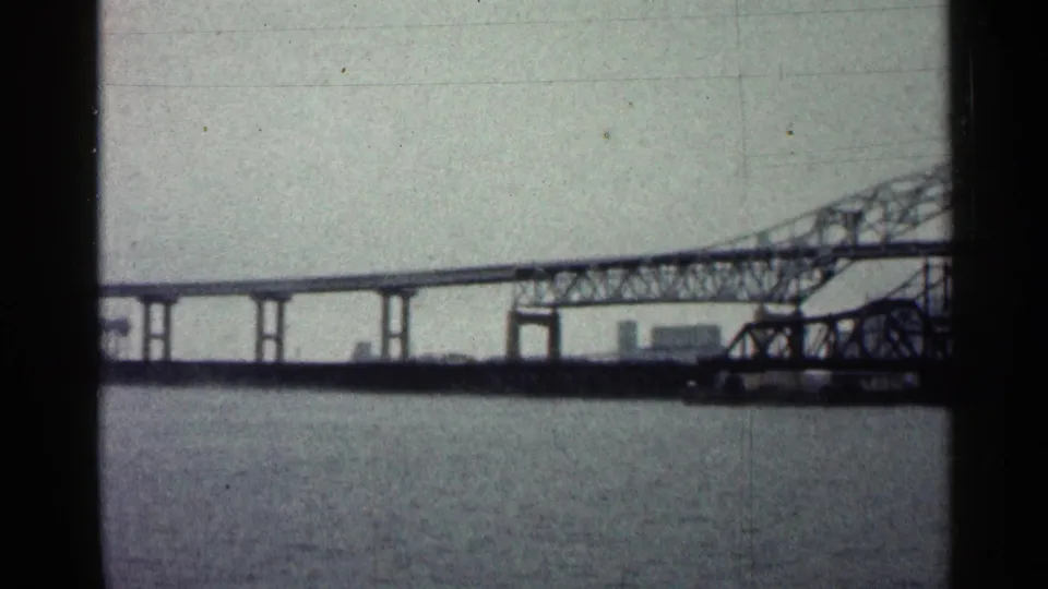 Duluth, Minnesota bridge view from 1960 footage, with a steel truss section and elevated roadway over the river.