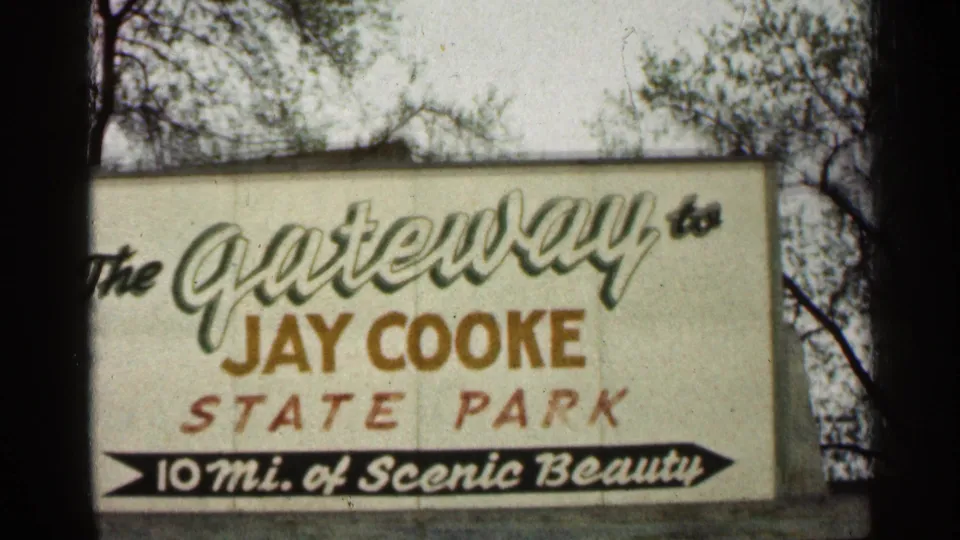 1960 Minnesota Super 8 frame showing a Jay Cooke State Park sign reading The Gateway to Jay Cooke State Park.