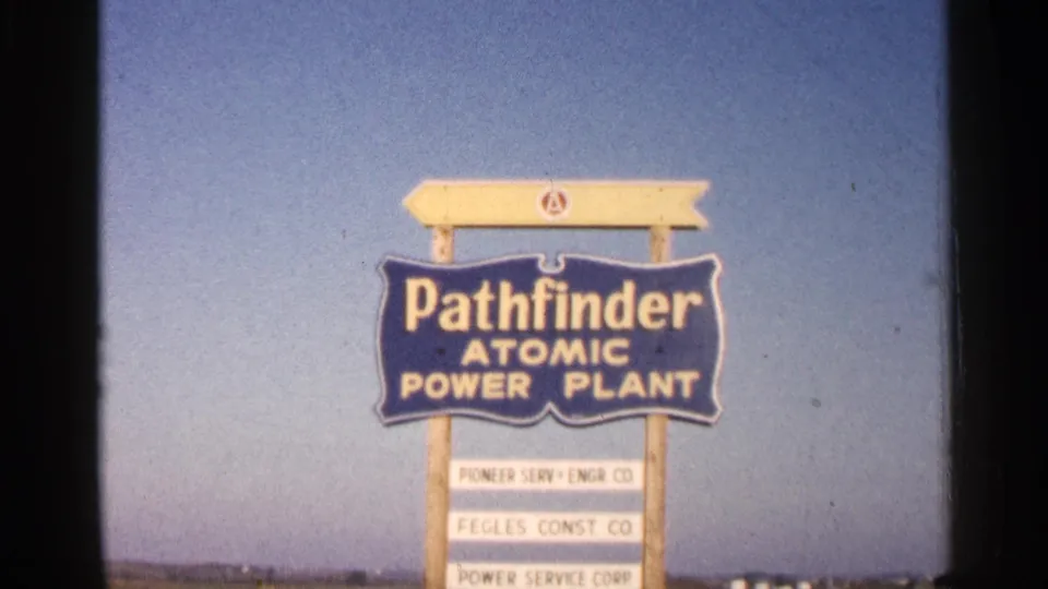 1960 8mm frame holding on the Pathfinder Atomic Power Plant sign with contractor or company panels below.
