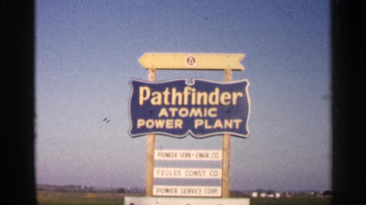 Pathfinder Atomic Power Plant sign in a rural field under a blue sky.