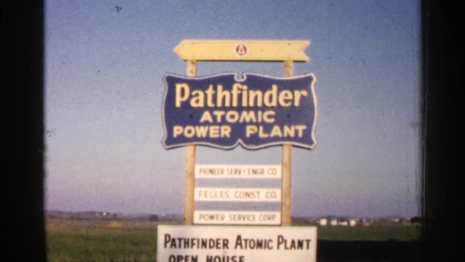 Sioux Falls, South Dakota 1960 frame with the Pathfinder Atomic Power Plant sign and lower open-house notice entering view.