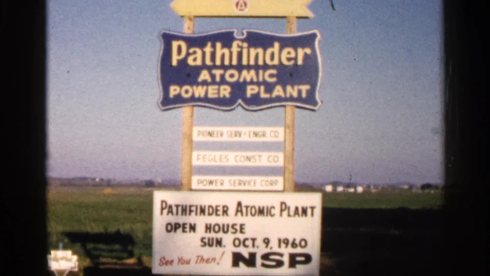 1960 Sioux Falls-area frame showing the Pathfinder sign, open-house date, and NSP lettering on the lower board.