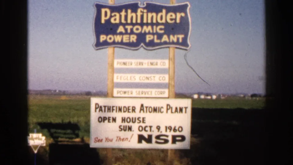 1960 Sioux Falls footage shows a Pathfinder Atomic Power Plant open-house sign with NSP branding beside open farmland.