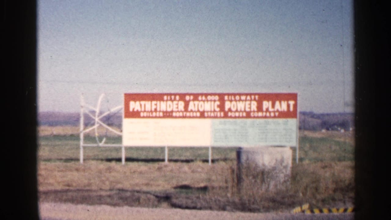 Roadside Pathfinder Atomic Power Plant sign appears against open land in Sioux Falls, South Dakota, in 1960 home-movie footage.