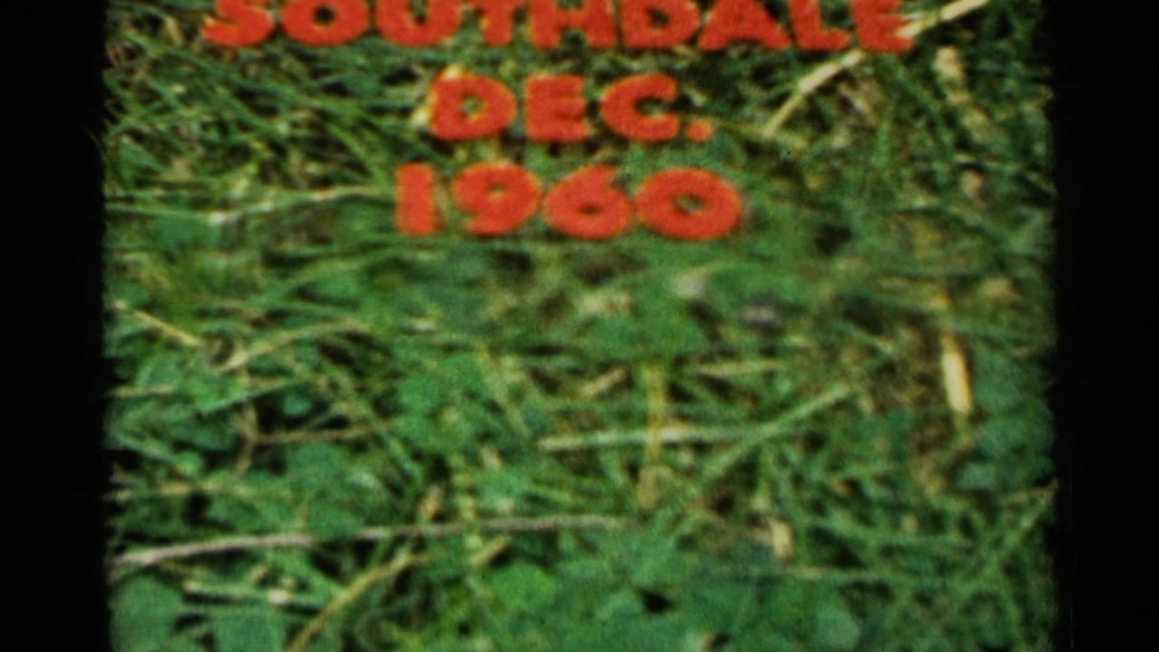 Red plastic lawn lettering in Sioux Falls home-movie footage spells SOUTHDALE above DEC. 1960 on grass.