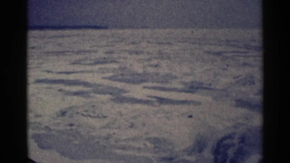 1961 Duluth winter landscape with snow-covered ridges, a muted horizon, and dark 8mm frame edges.