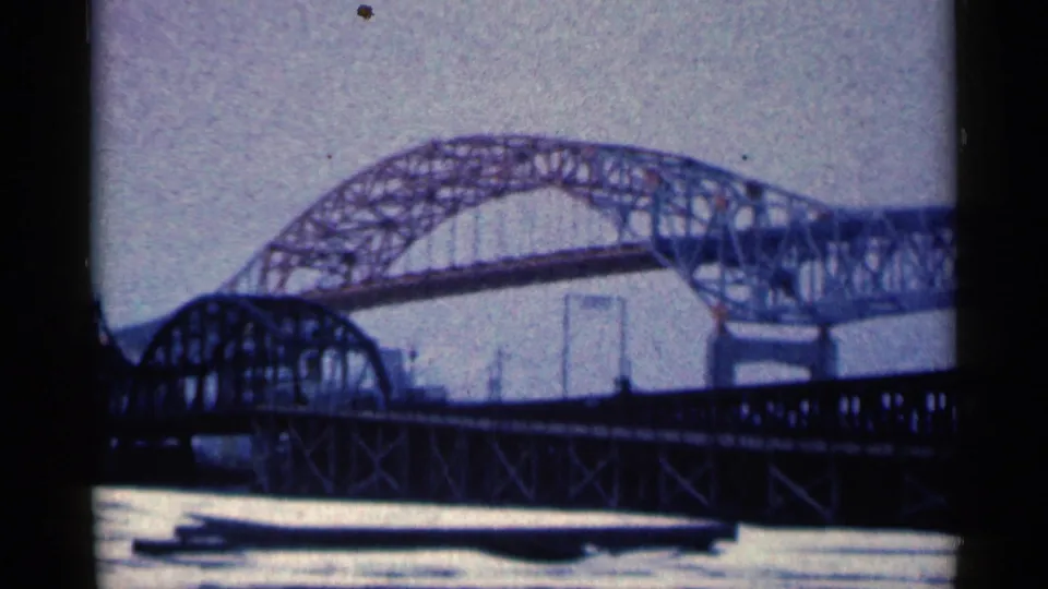 The final frame shows the Duluth river bridge from below, with the arched steelwork silhouetted against a muted sky.