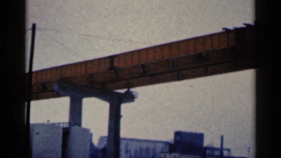 1961 Duluth 8mm still emphasizing the bridge underside, concrete supports, tank tops and industrial yard details.