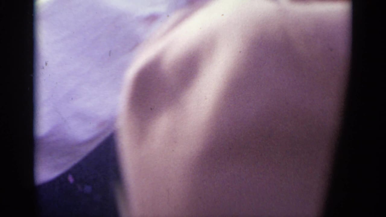 Blurred close view of a person's shoulder and nearby clothing.