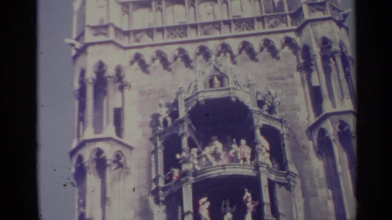 1961 Spain 8mm frame showing stacked balconies and distant figures against an ornate Gothic-style stone facade.