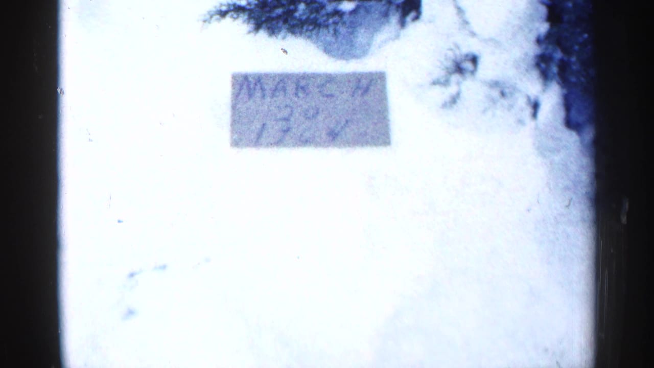 Handwritten March 17, 1964 date card beside snowy yard footage.
