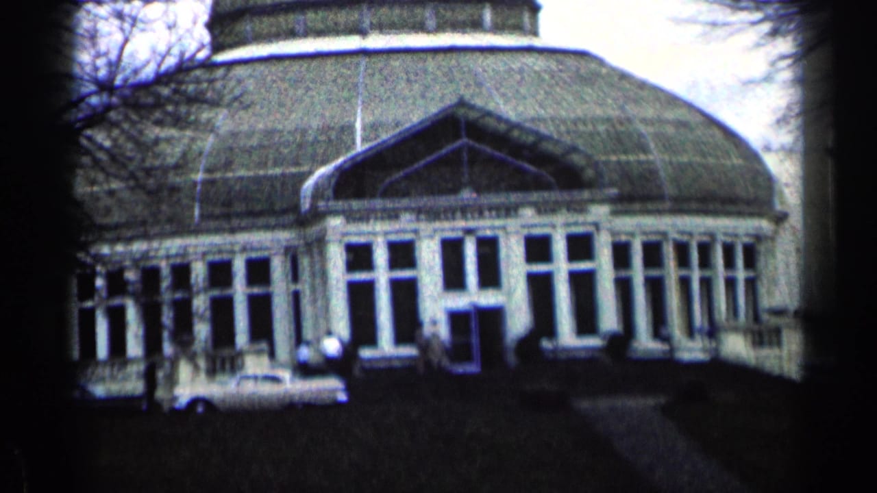 Domed conservatory exterior with glass windows and a dark doorway.