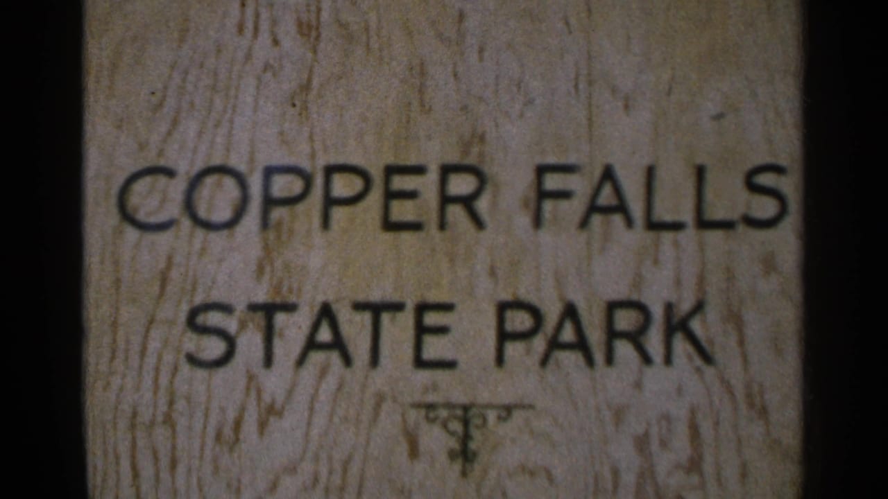 Close 8mm view of a wooden Copper Falls State Park sign with black lettering and visible wood grain.