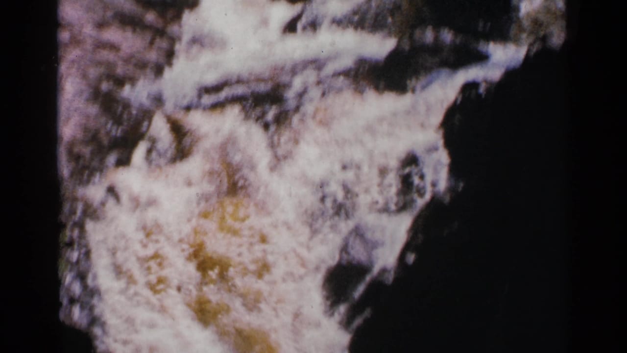 1964 Minnesota 8mm close view of turbulent Brownstone Falls water, with bright foam and dark rock partially visible.