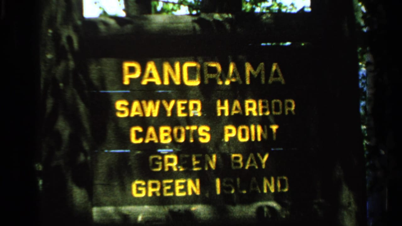 Dark wooden sign with yellow lettering listing Panorama and nearby scenic locations.
