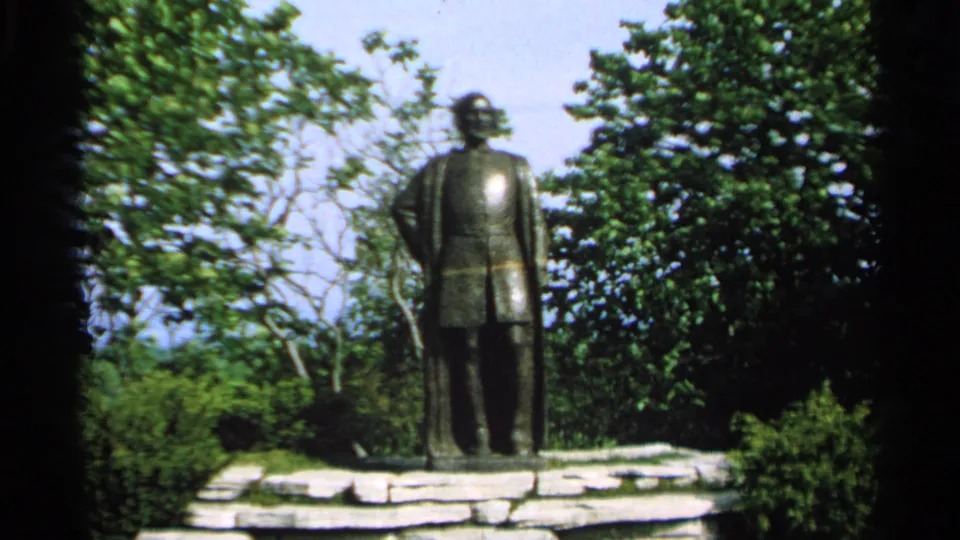Centered view of the Jean Nicolet memorial statue amid greenery on Washington Island, Wisconsin, in 1964.