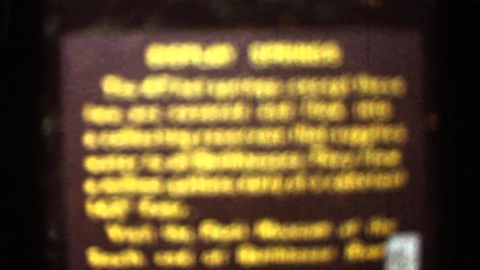 Arkansas 1965 8mm close-up of a brown park information sign with yellow text describing springs and water flow.