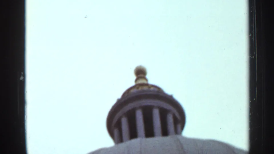 A domed feature with vertical openings rises against a bright sky in the 1965 Arkansas travel footage.