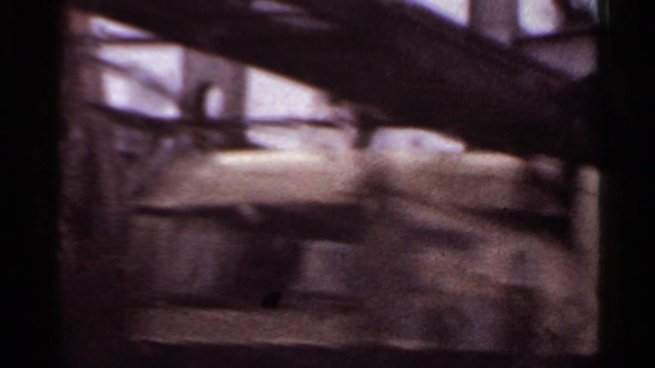 Blurred bridge structure and railing seen from a moving vehicle.