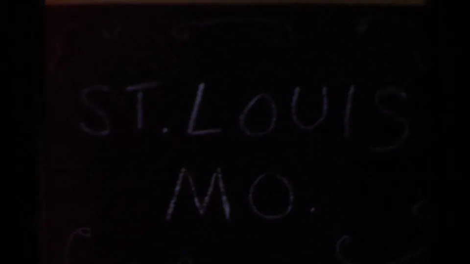 Home-movie contact frame includes a handwritten slate reading St. Louis Mo., supporting the location note for the surrounding field footage.
