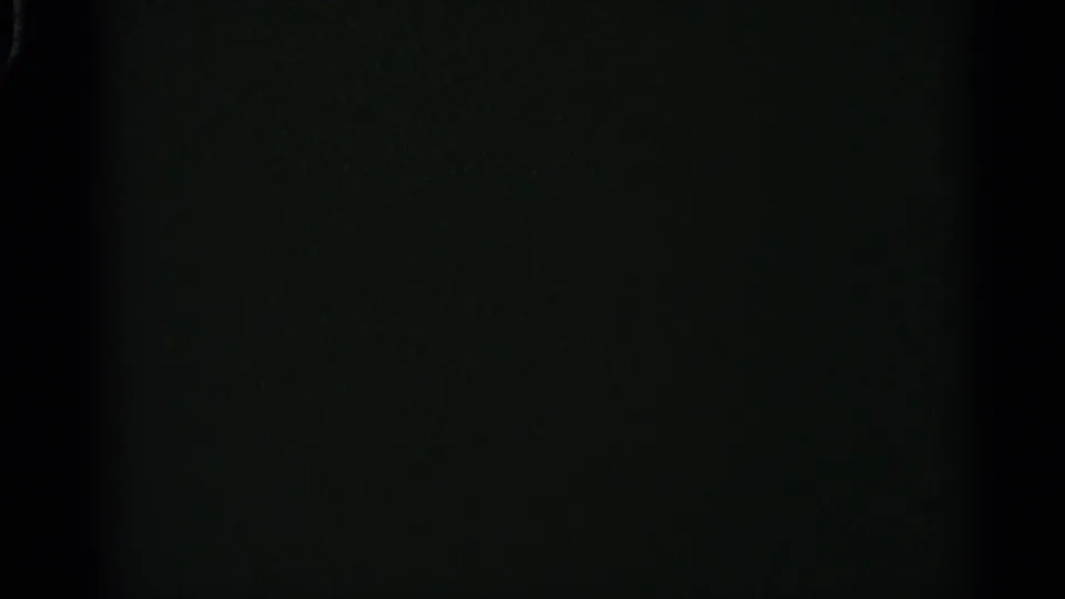 The clip ends on a dark 8mm frame with faint texture and no distinct visible street elements.