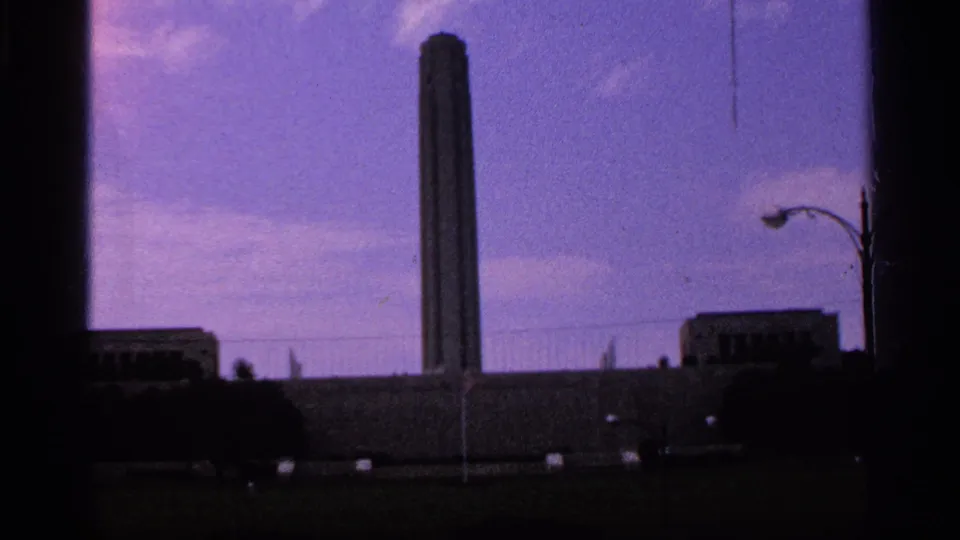 Kansas City landmark view from the 1965 8mm clip, with the Paseo Arch centered and a curved streetlight visible at right.