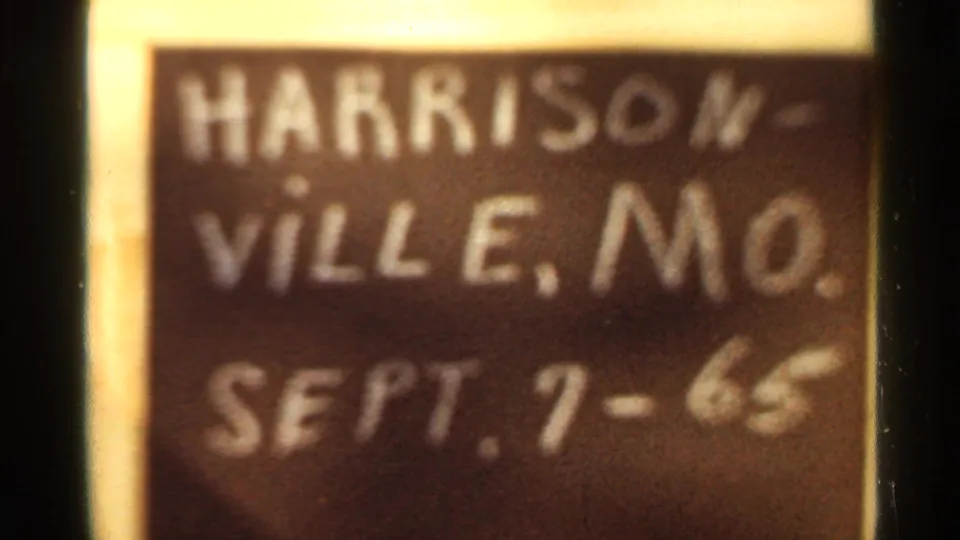 Close 8mm frame of a handwritten chalkboard title card reading Harrisonville, Mo. Sept. 7-65.