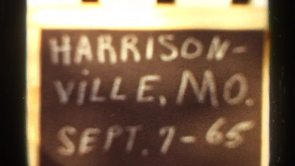 Final 1965 8mm frame holds on the Harrisonville, Mo. Sept. 7-65 chalkboard sign within film borders.