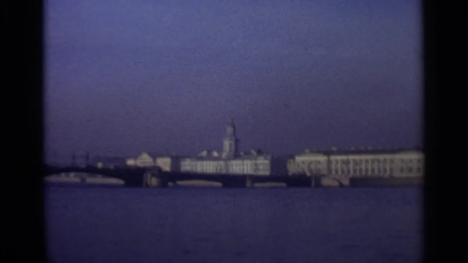 Distant Leningrad riverfront skyline in 1965, with classical buildings and a prominent tower across broad water.