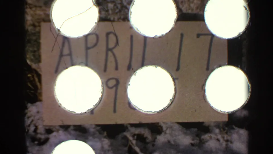 A handwritten home-movie date card shows April 17 and a partly visible 1965 marking, filmed against a snowy outdoor background.