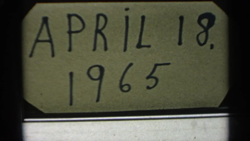 Handwritten date card reading April 18, 1965 appears next to the snowy 8mm frames.