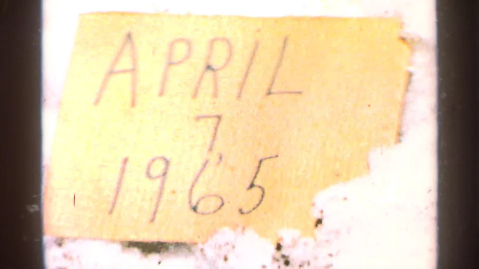 Handwritten date card for the reel reads April 7, 1965, filmed in soft focus with warm paper color and visible film grain.
