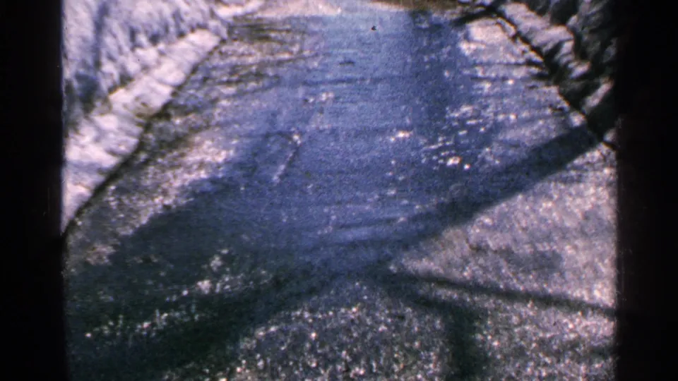 A snowy outdoor water channel or wet path appears after the date card in the 1965 Minnesota home-movie footage.