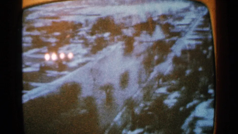 Soft, distorted 1965 Minnesota frame that may show a snowy road or town view, possibly filmed from a monitor.