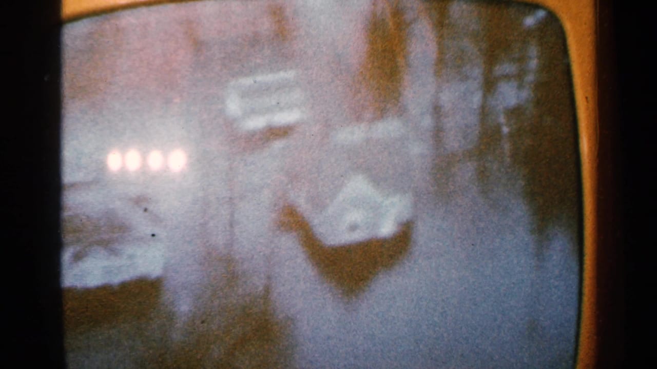 Soft, grainy view of floodwater and distant lights through rounded 8mm frame edges.